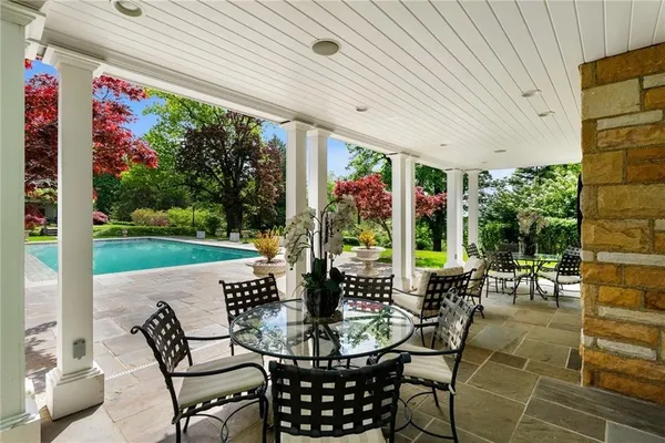 a view of an chairs and table in patio