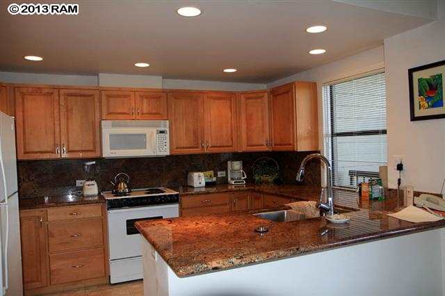 100 Ridge Road, Unit 2914 Lahaina, HI 96761 - Photo 4 of 24 a kitchen with kitchen island granite countertop a sink and a counter top space