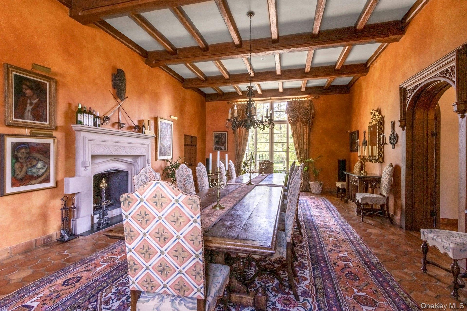 120 Ridge Road Tuxedo Park, NY 10987 - Photo 15 of 50 Dining room with beamed ceiling, arched walkways, a fireplace, and a chandelier