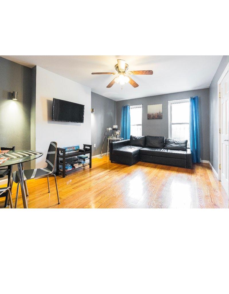 940 Bushwick Avenue Brooklyn, NY 11221 - Photo 2 of 7 Living room with ceiling fan and wood-type flooring