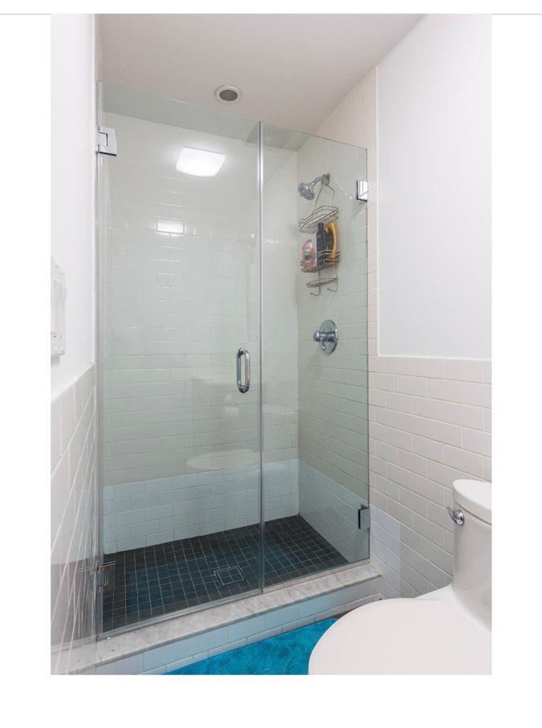 940 Bushwick Avenue Brooklyn, NY 11221 - Photo 4 of 7 Bathroom featuring toilet, tile walls, and walk in shower