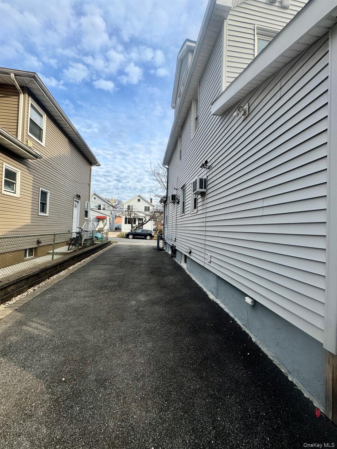 164-36 77th Road Queens, NY 11366 - Photo 19 of 20 a view of a street with a house