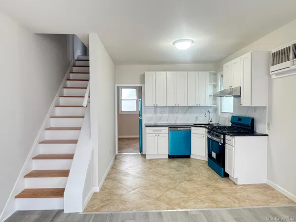 a kitchen with granite countertop a stove and a sink