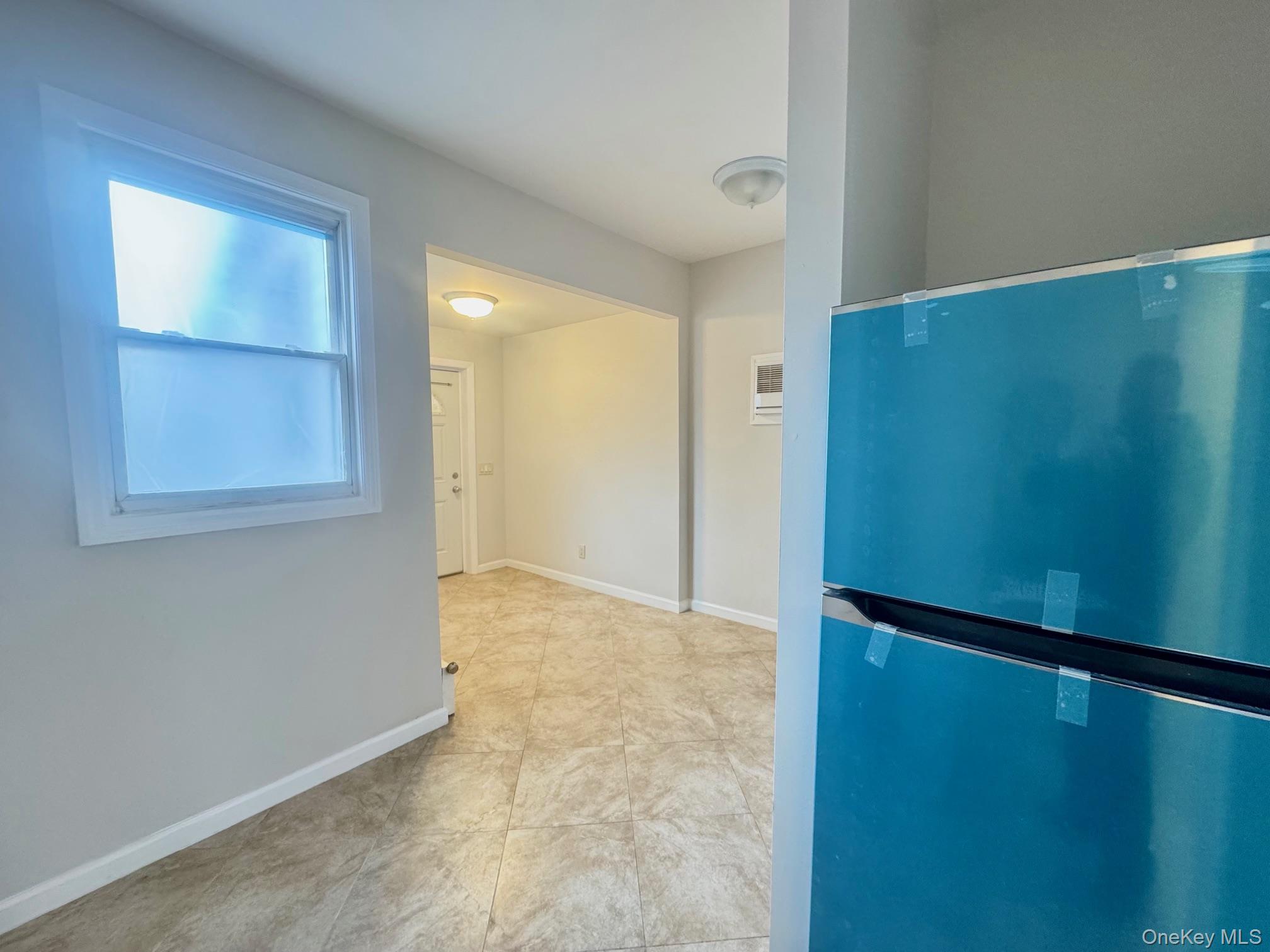 164-36 77th Road Queens, NY 11366 - Photo 4 of 20 an empty room with windows