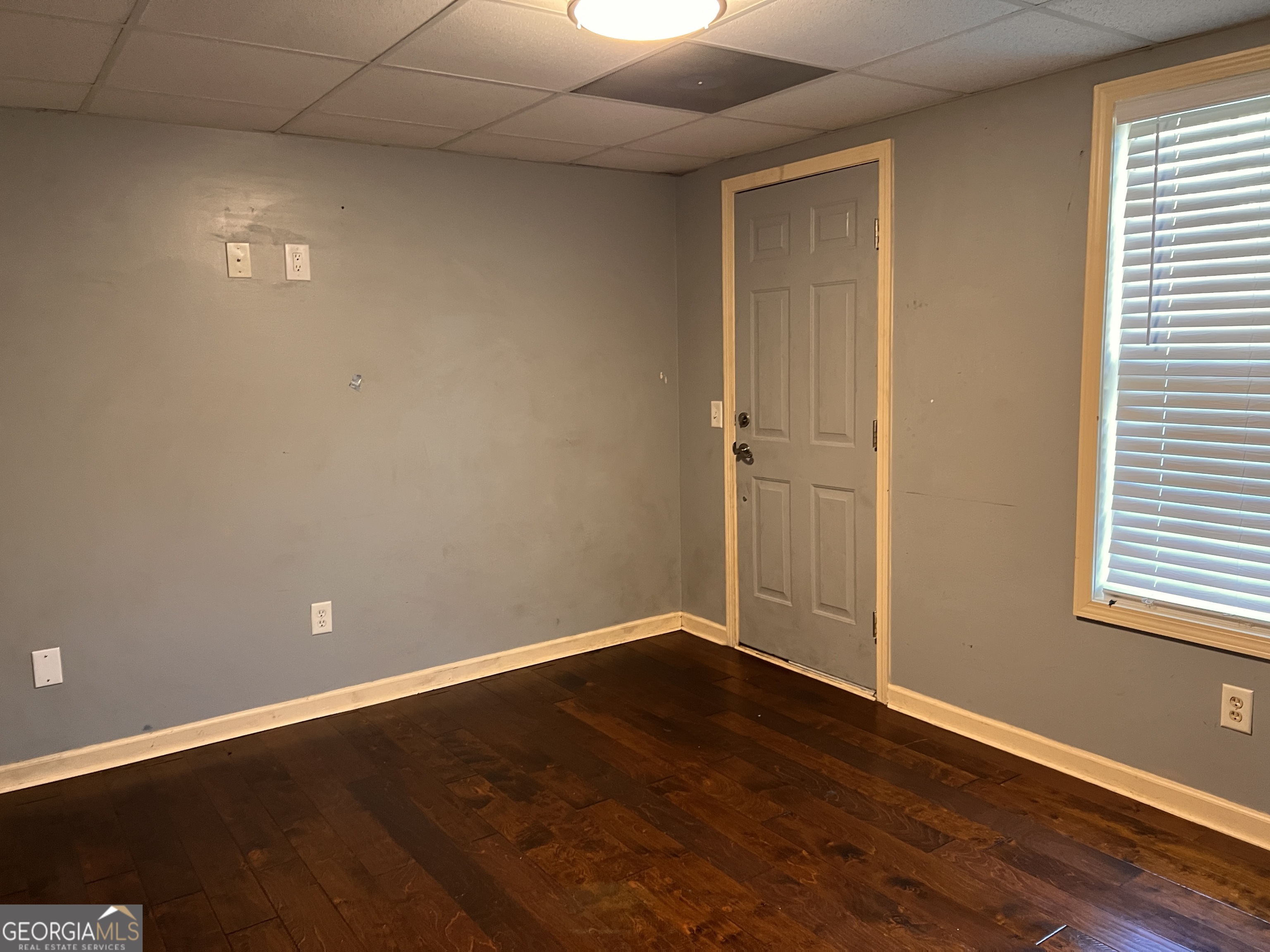 20 Triangle Lane Adairsville, GA 30103 - Photo 14 of 17 a view of an empty room with wooden floor and a window