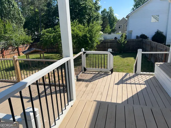 a view of balcony with furniture and wooden floor