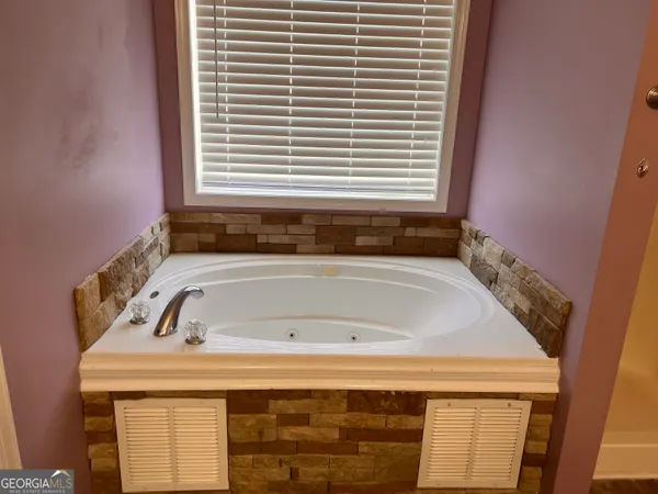 a bathroom with a bath tub and a window