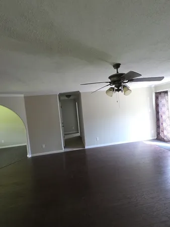 a view of room with a ceiling fan and hardwood floor
