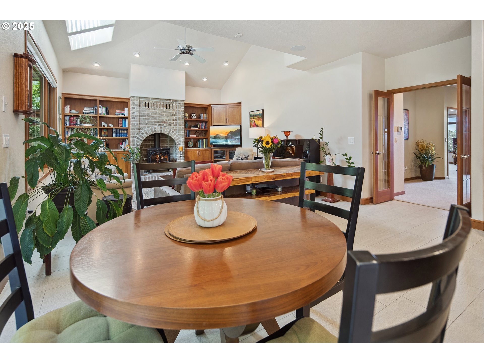 17514 Brookhurst Drive Lake Oswego, OR 97034 - Photo 12 of 37 a dining room with furniture a potted plant and a fireplace