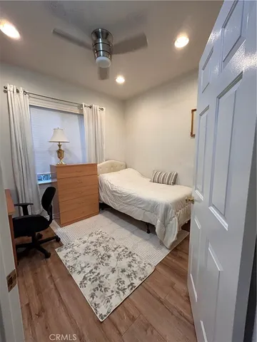 a bedroom with a bed and window