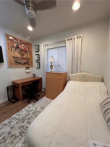 a bedroom with a bed and a dresser