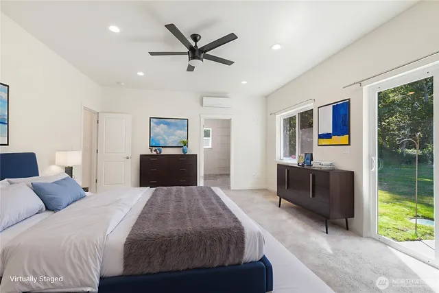 a bedroom with a bed and a large mirror