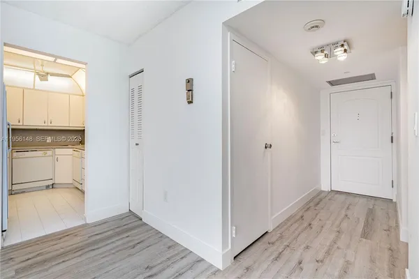 a view of hallway with wooden floor