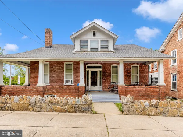 a front view of a house with many windows