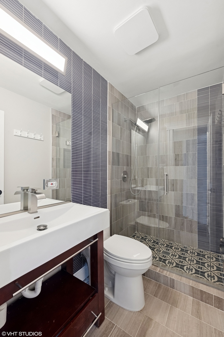 932 60th Place Downers Grove, IL 60516 - Photo 13 of 25 a bathroom with a sink a toilet and shower