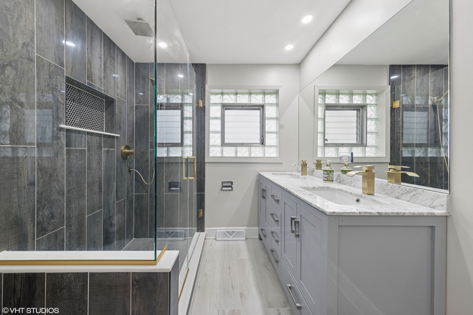 932 60th Place Downers Grove, IL 60516 - Photo 10 of 25 a bathroom with a sink a toilet a shower and a large mirror