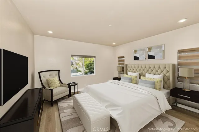 a spacious bedroom with a bed a couch and a window