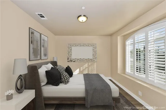 a bedroom with a bed and a window