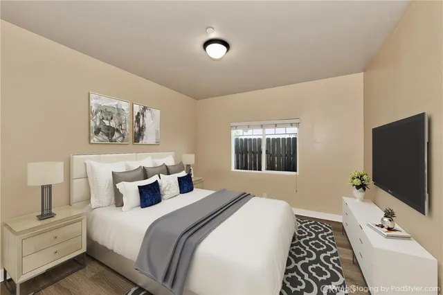 a bedroom with a bed and a flat screen tv