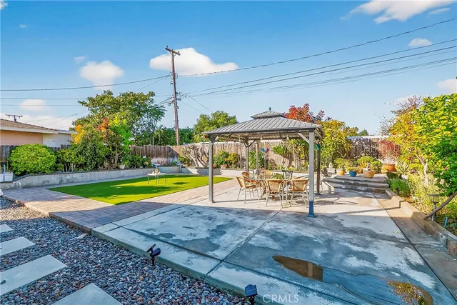 a view of a swimming pool with a bench and lawn chairs