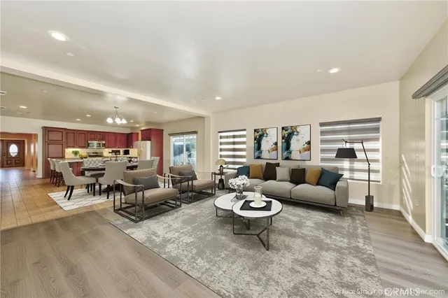 a living room with lots of furniture and view of kitchen