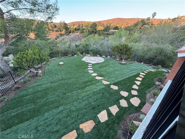 a view of a lush green forest with lots of trees