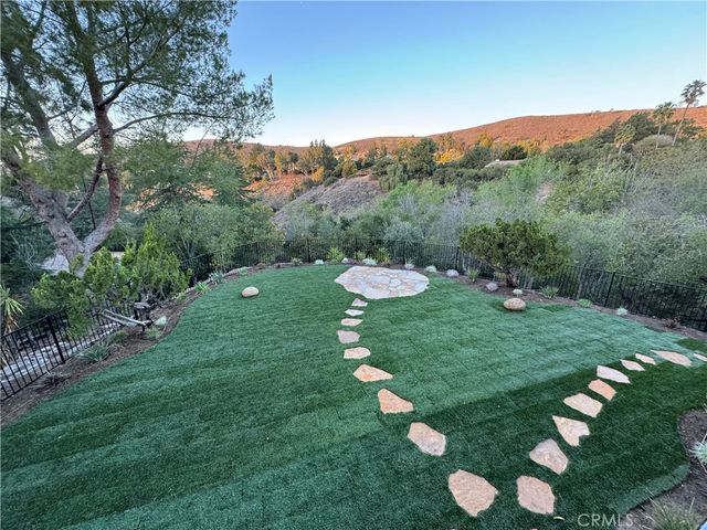 a view of a table and chairs in the garden
