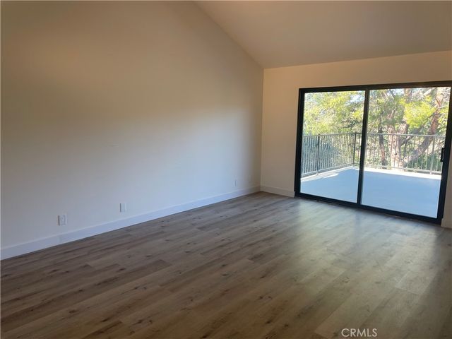 a view of a room with wooden floor and window
