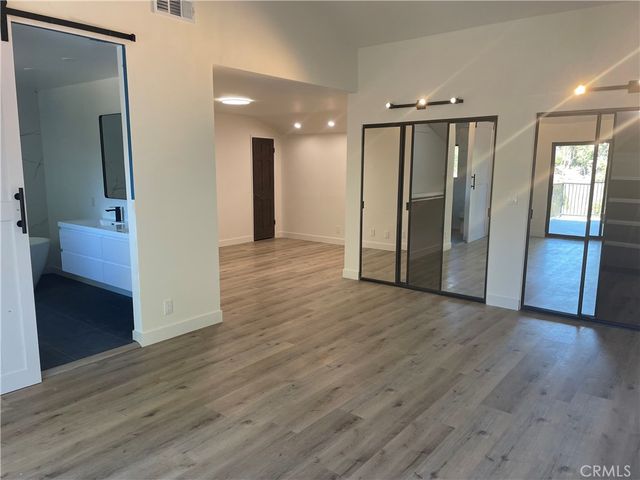 a view of hallway with wooden floor