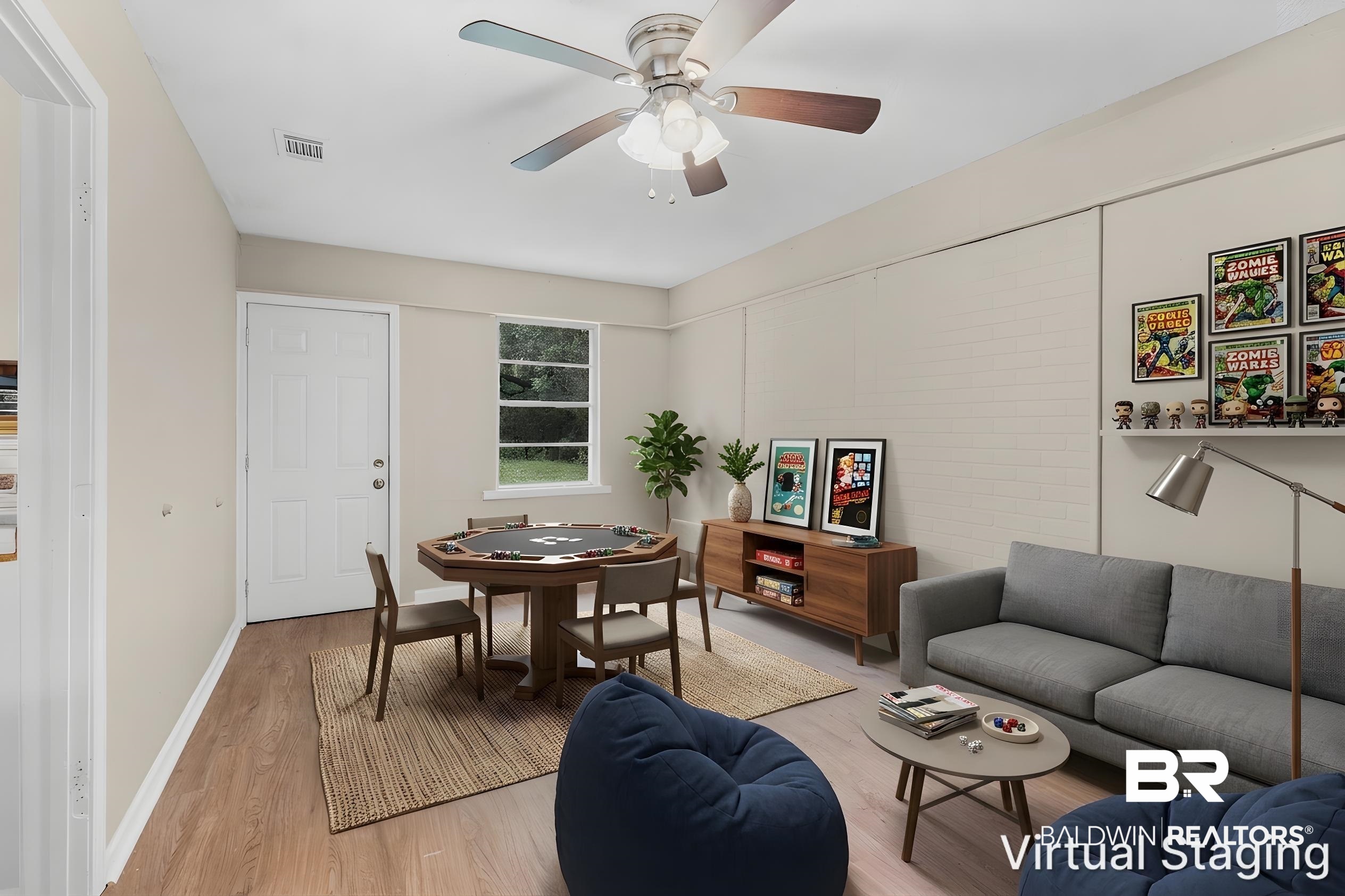 1560 Military Road Mount Vernon, AL 36560 - Photo 13 of 26 Spacious room featuring wood-finish flooring, a ceiling fan with integrated lighting, a functional window, and a white paneled door