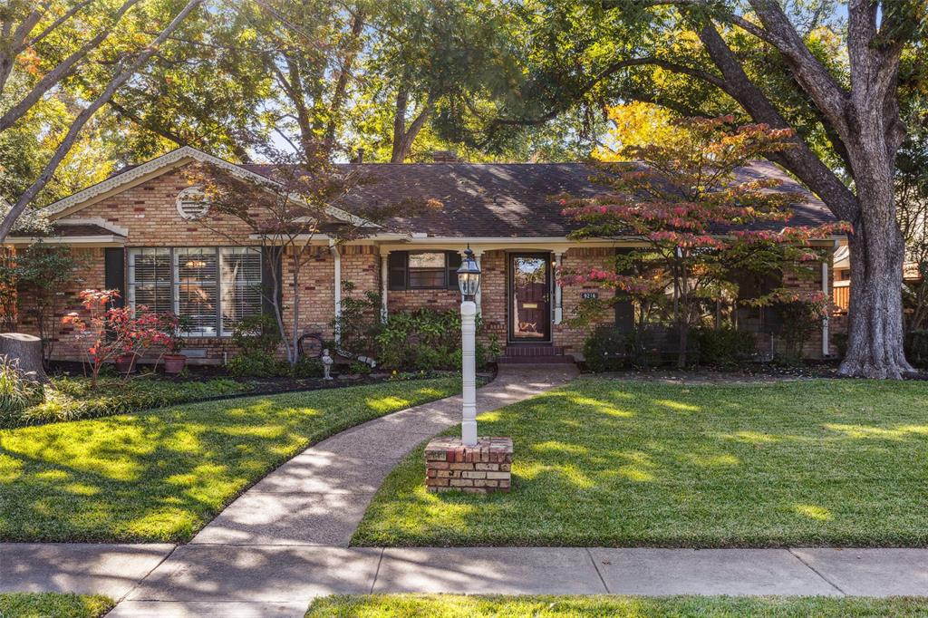 a front view of a house with a yard table and chairs