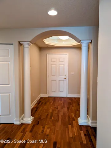 an empty room with wooden floor and closet