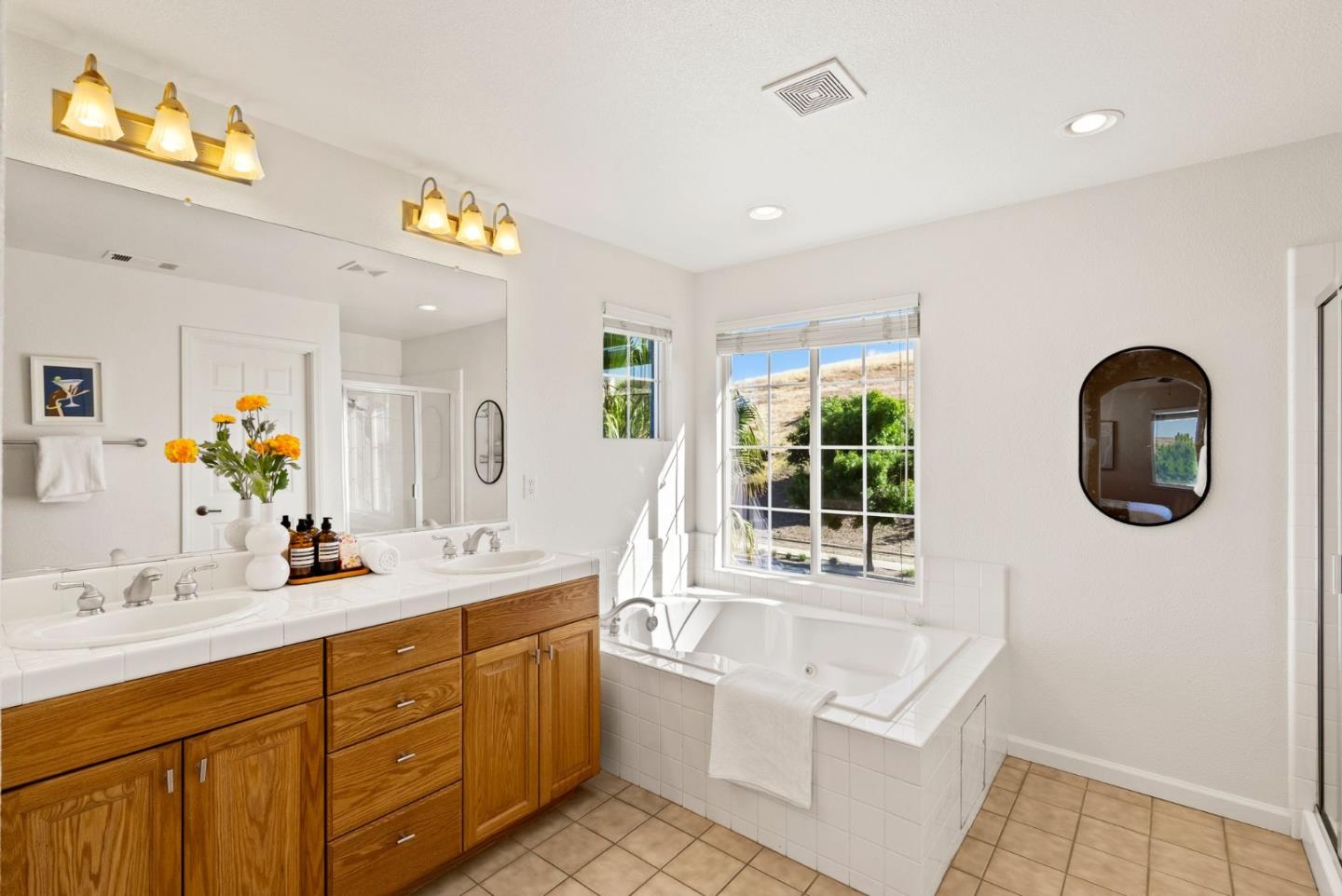 4863 Greencastle Way Antioch, CA 94531 - Photo 33 of 52 a bathroom with a double vanity sink a mirror and a bathtub