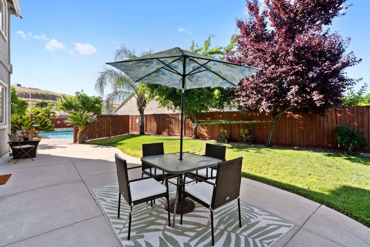 4863 Greencastle Way Antioch, CA 94531 - Photo 39 of 52 a patio with a table and chairs under an umbrella