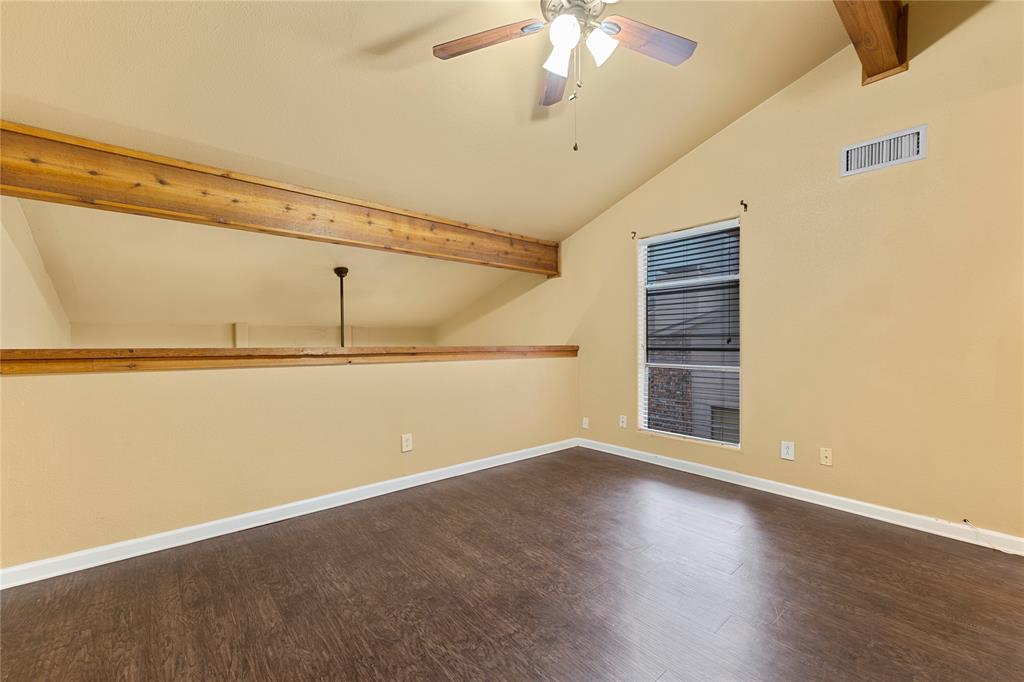 5516 Boca Raton Boulevard, Unit 310 Fort Worth, TX 76112 - Photo 10 of 19 an empty room with wooden floor and windows