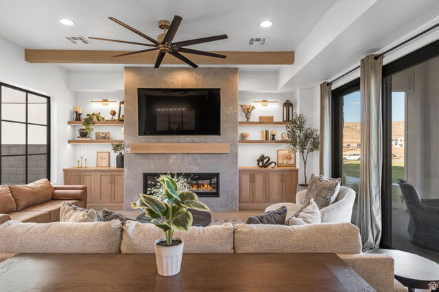 5367 Cyan Lane St. George, UT 84790 - Photo 29 of 49 Living space featuring a stone-clad fireplace, integrated media center, recessed lighting, and a large ceiling fan