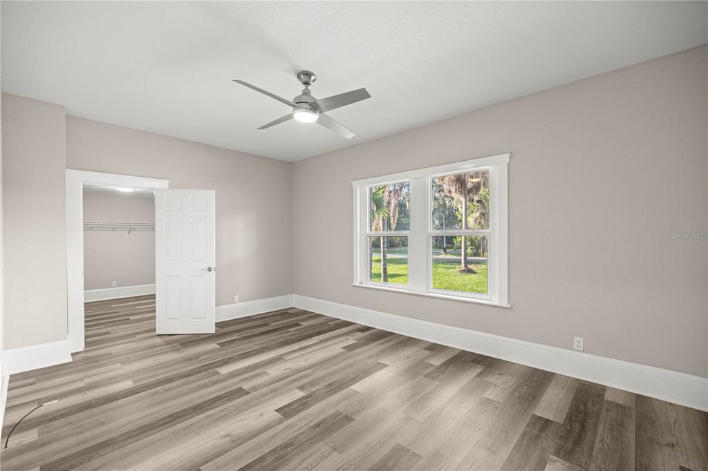 4609 Northeast 7th Street Ocala, FL 34470 - Photo 22 of 36 a view of an empty room with wooden floor and a window