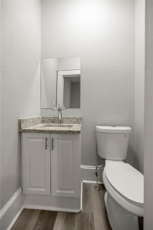 4609 Northeast 7th Street Ocala, FL 34470 - Photo 24 of 36 a bathroom with a granite countertop toilet and a sink