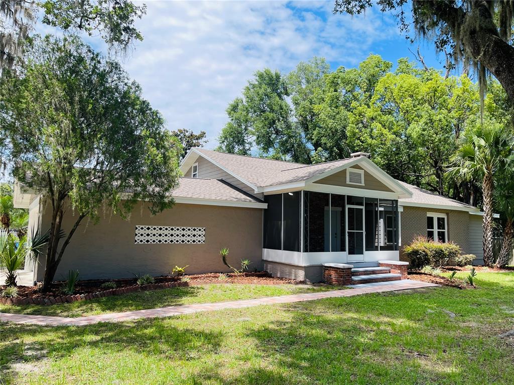 4609 Northeast 7th Street Ocala, FL 34470 - Photo 3 of 36 a view of a house with a yard and large tree