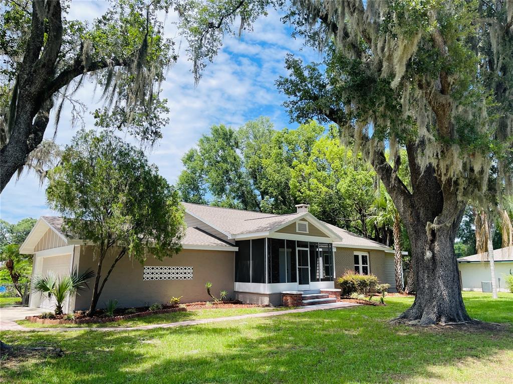 4609 Northeast 7th Street Ocala, FL 34470 - Photo 4 of 36 a front view of a house with garden