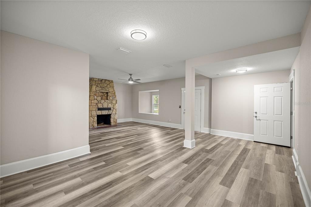 4609 Northeast 7th Street Ocala, FL 34470 - Photo 9 of 36 a view of an empty room and wooden floor