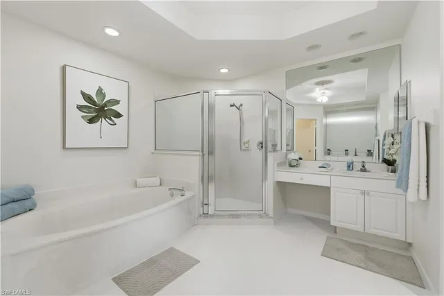a bathroom with a bathtub a shower a sink and a mirror