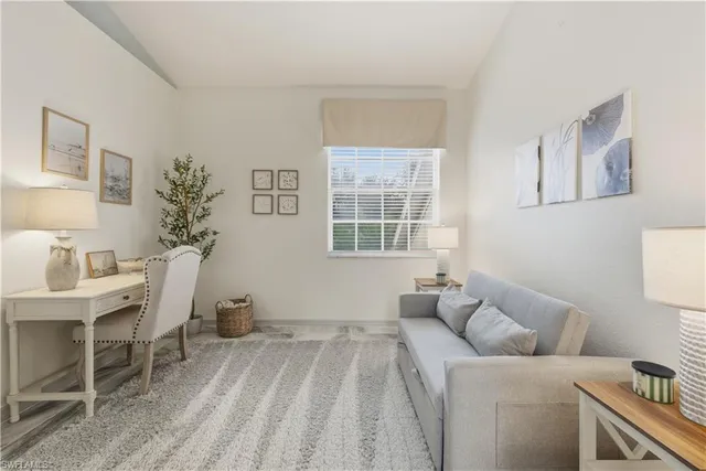 a living room with furniture a window and a table