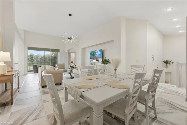 a view of a dining room with furniture large windows and wooden floor