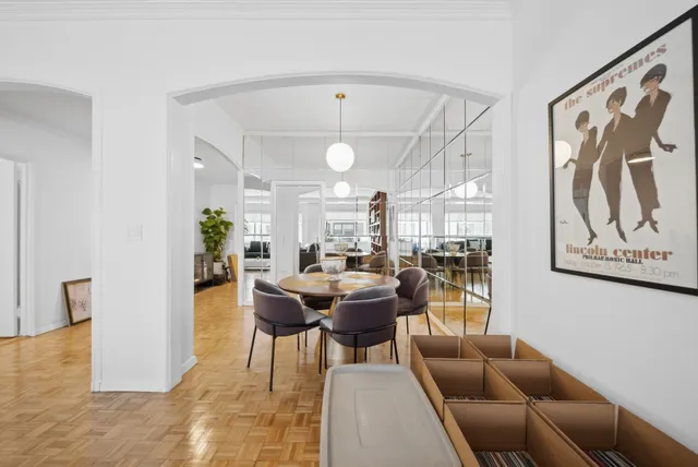 a living room with furniture and a bookshelf