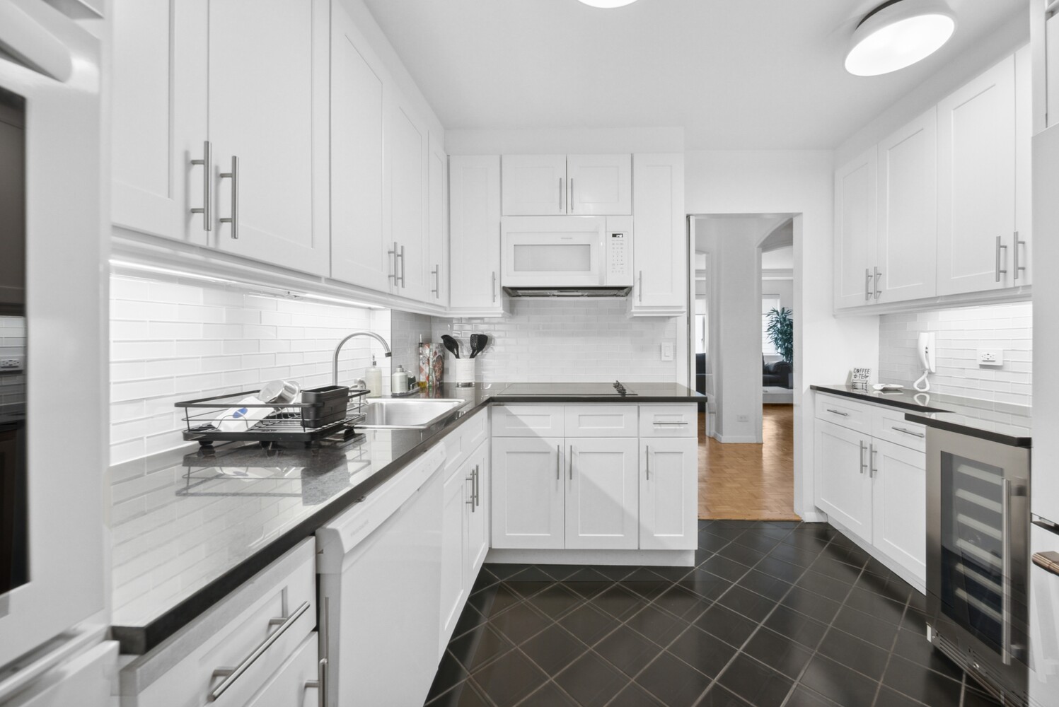 475 Park Avenue, Unit 8D Manhattan, NY 10022 - Photo 5 of 9 a kitchen with stainless steel appliances granite countertop a sink stove refrigerator and cabinets
