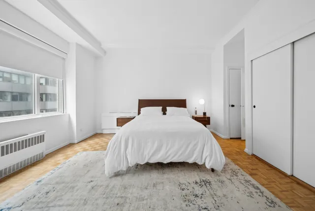 a bedroom with a bed and a window