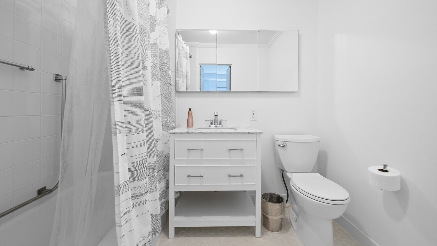 475 Park Avenue, Unit 8D Manhattan, NY 10022 - Photo 7 of 9 a bathroom with a toilet sink and a mirror