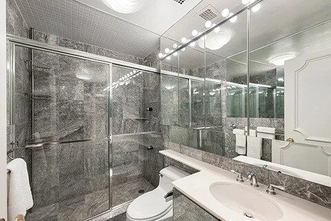 475 Park Avenue, Unit 8D Manhattan, NY 10022 - Photo 8 of 9 a bathroom with a sink toilet and shower