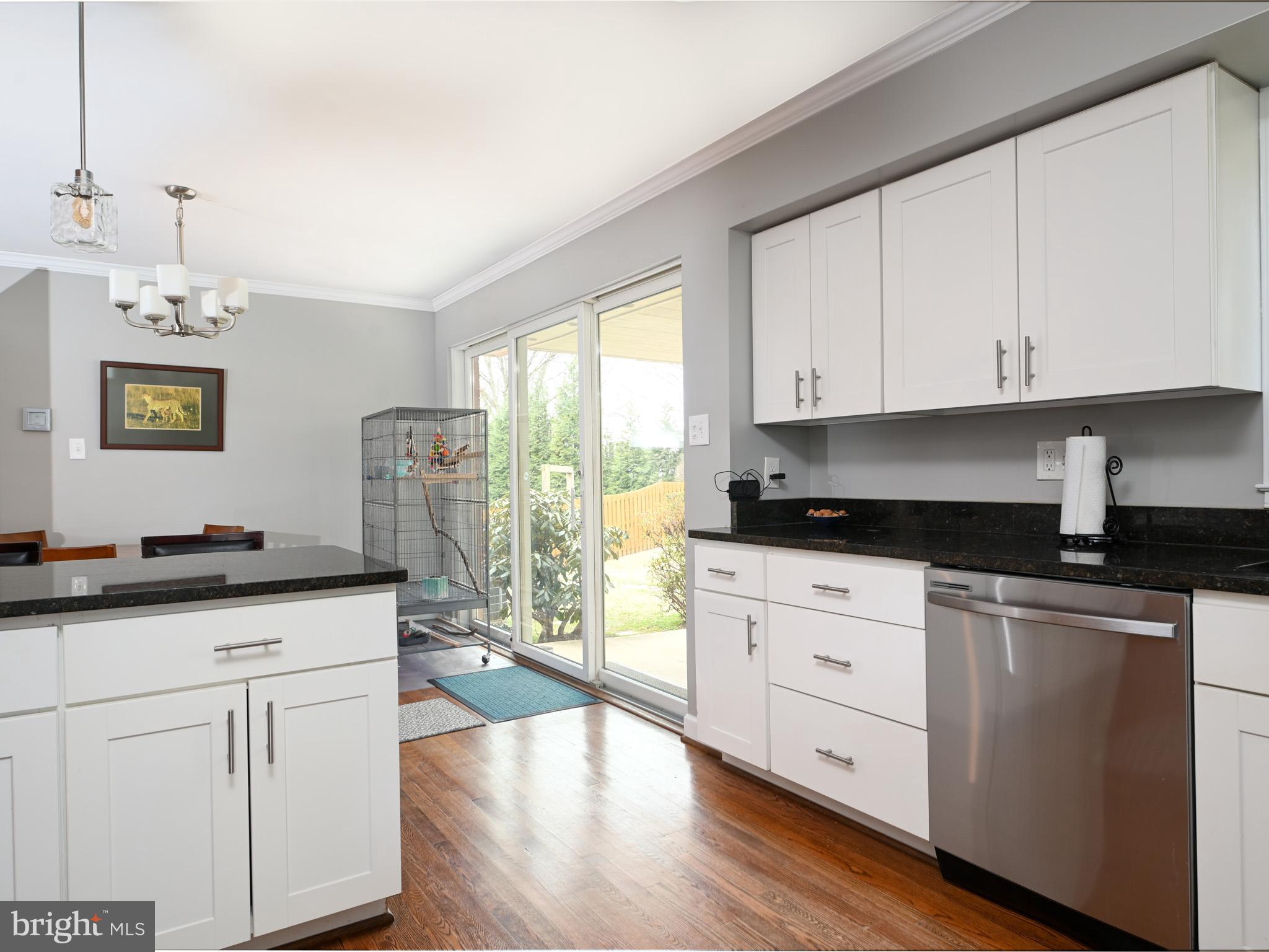 7951 Jansen Drive Springfield, VA 22152 - Photo 11 of 36 a kitchen with granite countertop white cabinets white appliances a sink and a large window